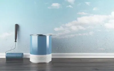 can of paint next to blue wall