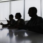 Silhouette of business people negotiating at meeting table