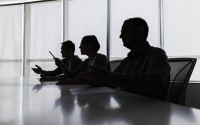 Silhouette of business people negotiating at meeting table