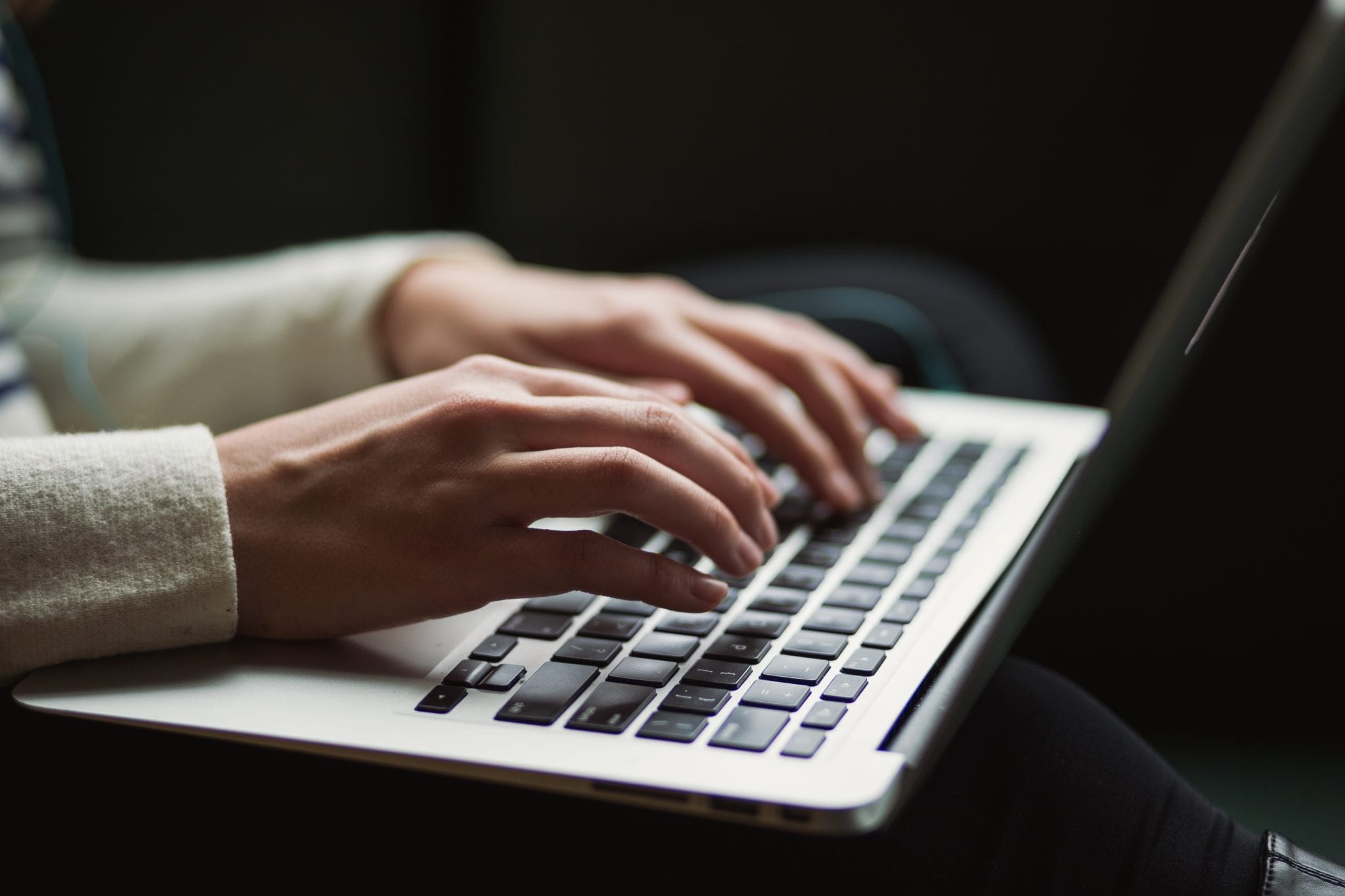 woman typing on her laptop