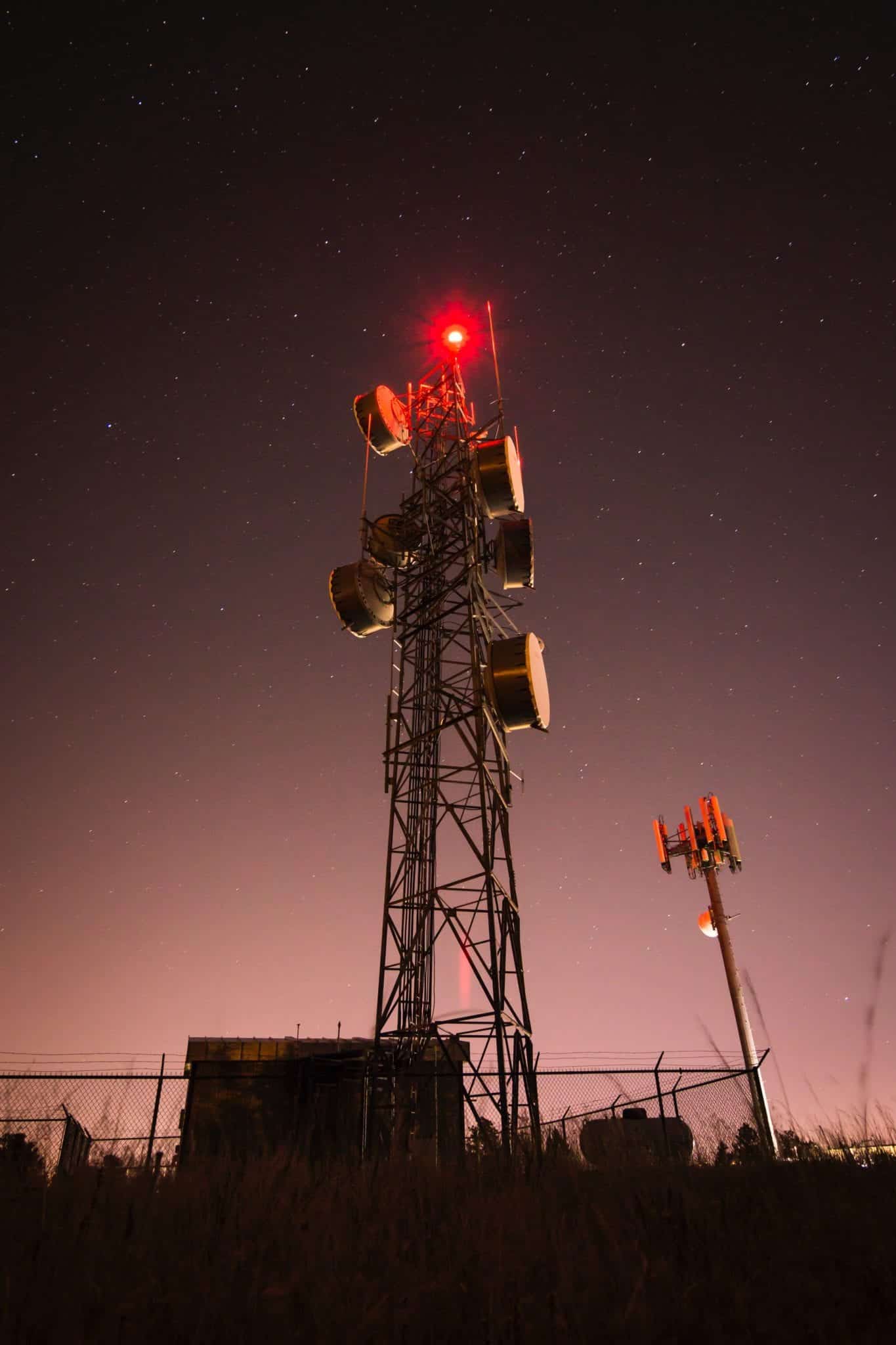 Communications tower viewed at night — American Coatings Association