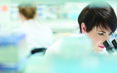 female scientist in a busy research lab