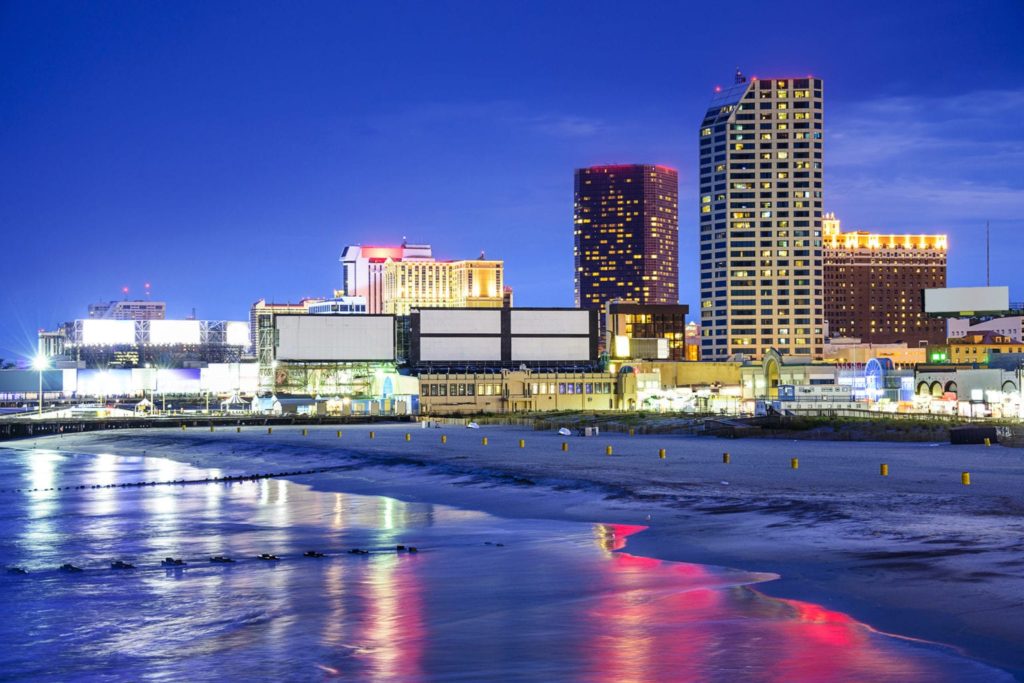 Atlantic City, New Jersey, USA resort casinos cityscape on the shore at night.