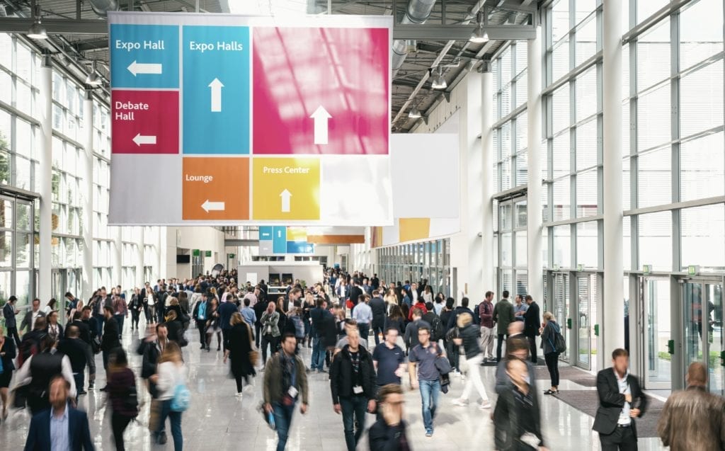 Crowd of anonymous Business people walking at a trade fair