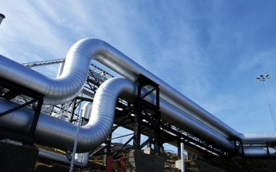 Industrial zone, Steel pipelines and valves against blue sky