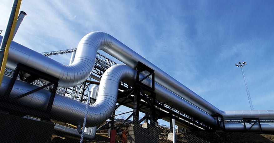 Industrial zone, Steel pipelines and valves against blue sky