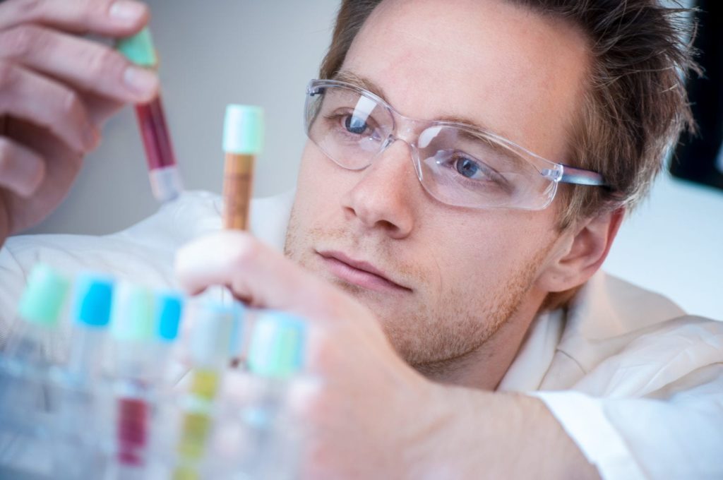 Scientist Comparing Results in his laboratory