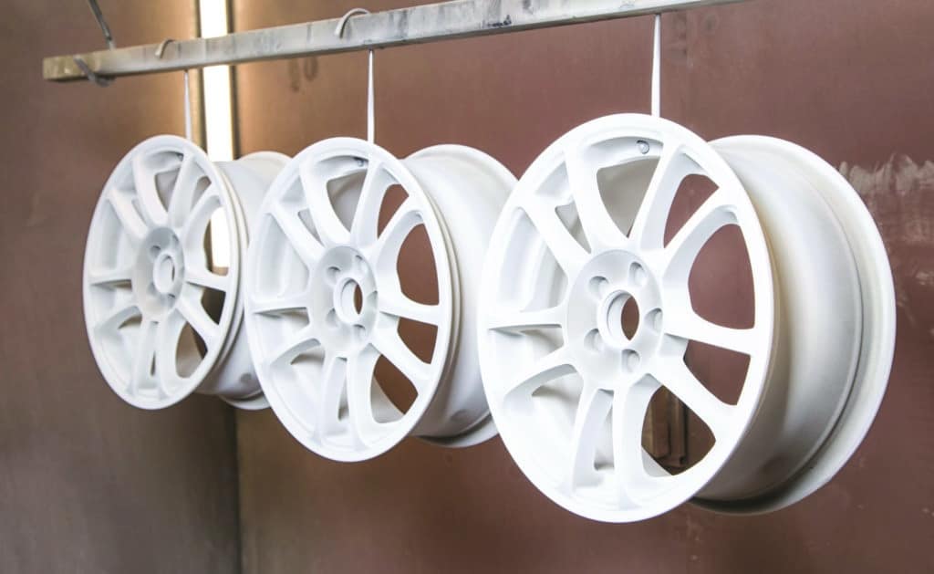 Process of powder coating auto wheels in workshop