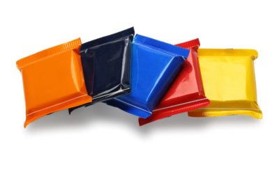 Row of Chocolate Bars In Colourful Plastic Wrappers on White Background