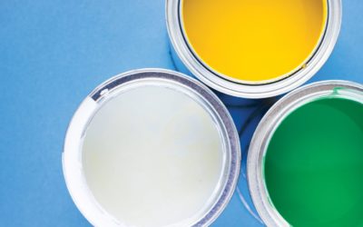 House renovation, paint cans on blue background top view