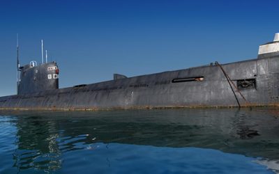 Russian submarine surfaced. Shot at water level against clear blue sky
