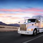 Truck and highway at sunset - transportation background