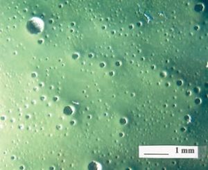 FIGURE 9—Diagram of a cross section of a gassing “pipeline” from a void in the plastic part through the layers of coating.