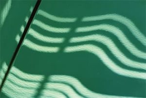 FIGURE 5—Orange peel as seen in the reflection of overhead lamps on a car hood. 