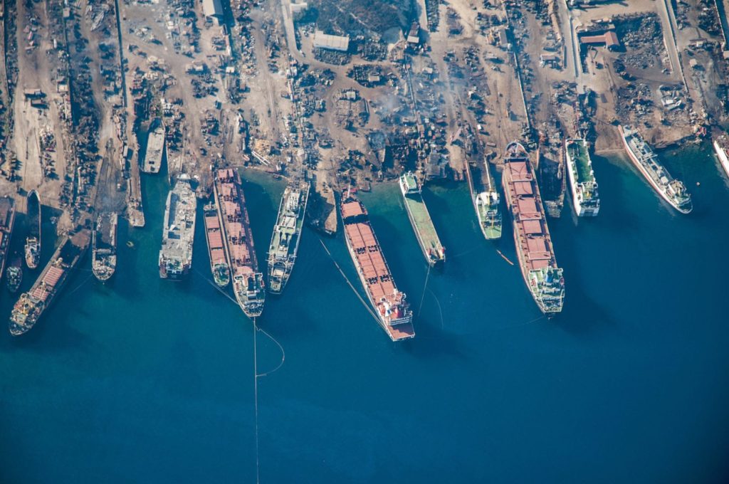 aerial view of a shipyard full of shipwrecks