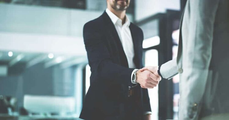 Closeup shot of two business people shaking hands in an office