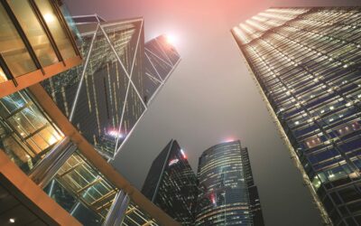 Perspective view of building in downtown hong kong city with light at night time.