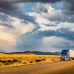 Semi trailer truck on highway at sunset