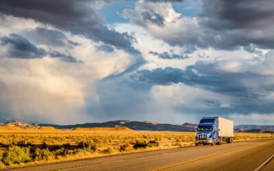 Semi trailer truck on highway at sunset