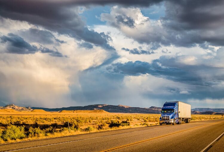 Semi trailer truck on highway at sunset