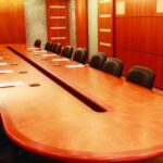 Conference room with large wooden table and leather chairs