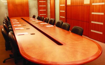 Conference room with large wooden table and leather chairs