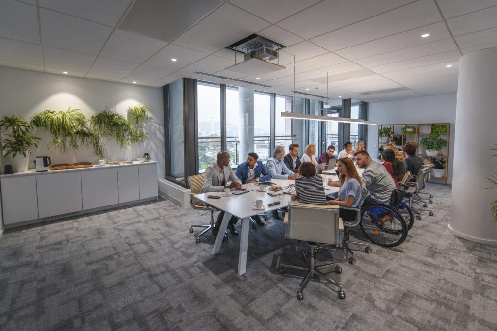 Executive Team Sitting at Conference Table in Board Room