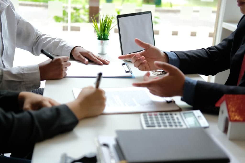 Persons signing contract for business agreement.