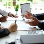Persons signing contract for business agreement.