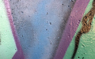 a colorful abstract image of paint on concrete