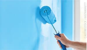 paint roller on blue wall