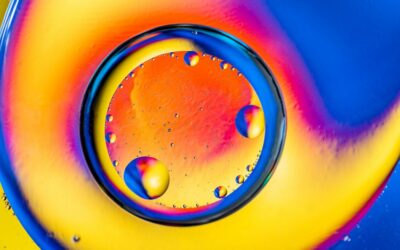 Abstract background with colorful gradient colors. Oil drops in water abstract psychedelic pattern image. Blue orange yellow colored abstract pattern