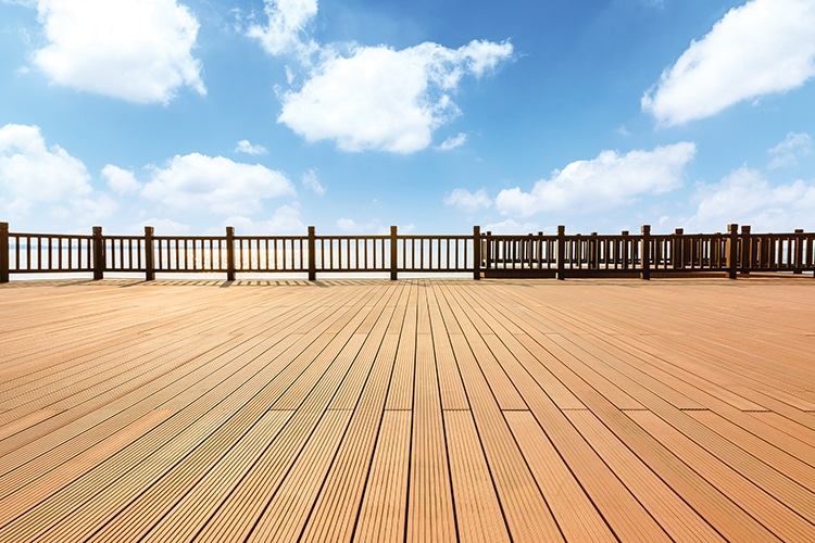 Lakeside wood floor platform and blue sky with white clouds