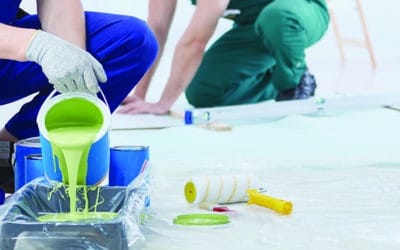 House painter pouring green paint