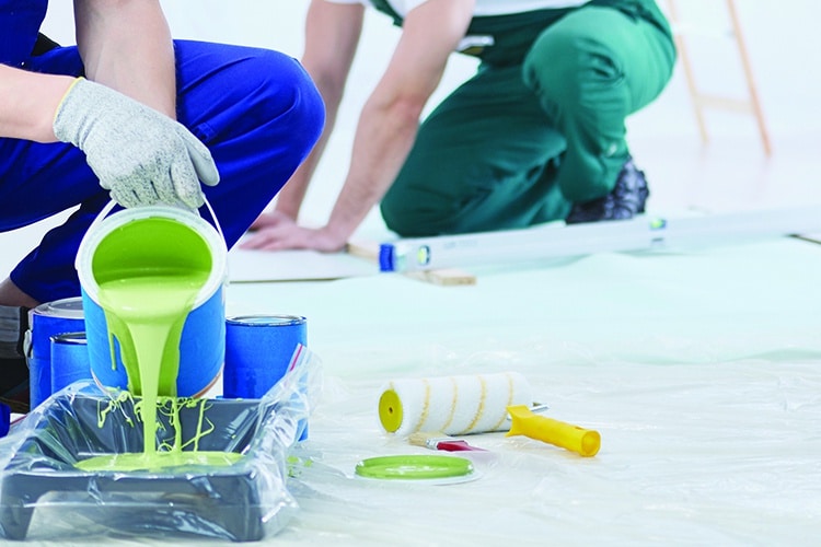 House painter pouring green paint