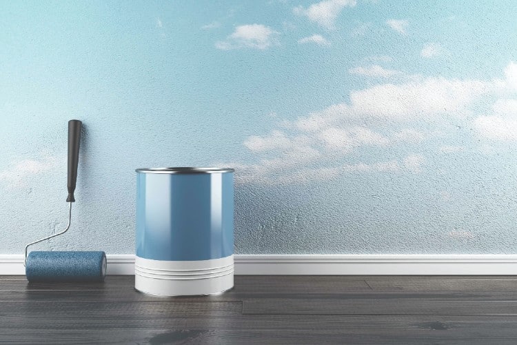 can of paint next to blue wall