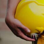 Construction worker with hardhat and tool belt