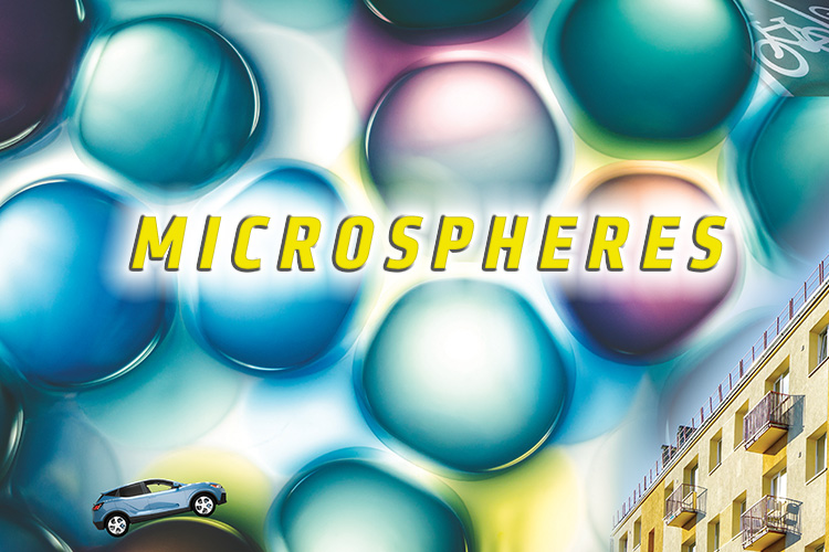 Graphic of a headline reading "Microspheres" on a background of colorful microscopic bubbles that resemble water droplets. A tiny SUV drives over the top of one of these bubbles, and a picture of the side of a building is used decoratively in the corner of the graphic.