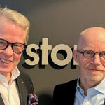 Jan Secher (left) and Ib Jensen (right) in front of a wall with the Perstorp Group logo.