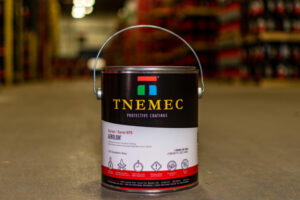A paint can of Tnemec Series 975 sits on a warehouse floor.
