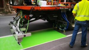 machine applying green bike paint