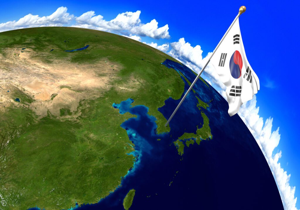 3D render of the national flag of South Korea over the geographic location of the country on a world map. Parts of this image furnished by NASA.