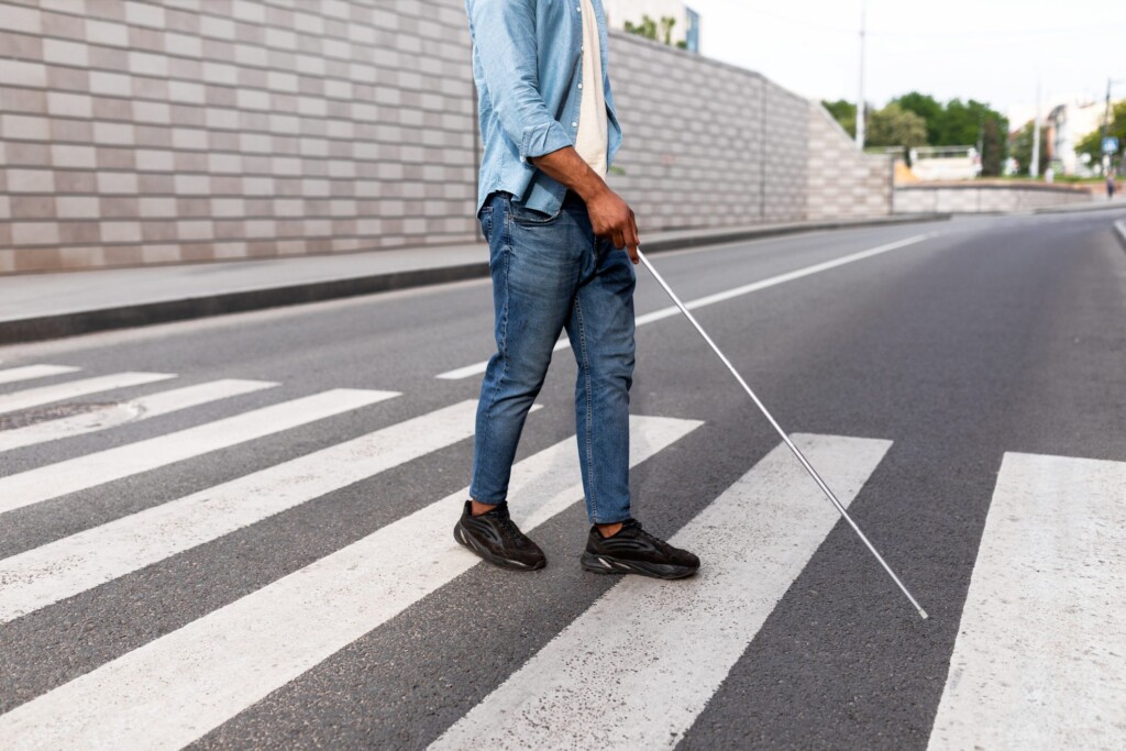 visually impaired man in crosswalk