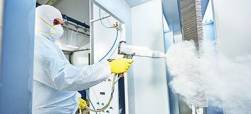 coatings specialist spraying white powder coating